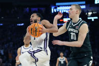 Kansas State guard Markquis Nowell (1) makes a layup as Michigan State forward Joey Hauser (10) defends in overtime of a Sweet 16 college basketball game in the East Regional of the NCAA tournament at Madison Square Garden, Thursday, March 23, 2023, in New York. (AP Photo/Frank Franklin II)