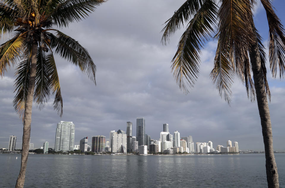 FILE- This Feb. 2, 2018, file photo shows the skyline of Miami on the horizon of Biscayne Bay in Miami. For more than a year, cities around the country, waited in suspense over whether they'd be chosen as Amazon's second home. Amazon’s search for a new home resulted in over 200 suitors from across the continent that the company in January whittled down to 20, stretching from Toronto to Miami in the east to Denver and Los Angeles out west. (AP Photo/Lynne Sladky, File)