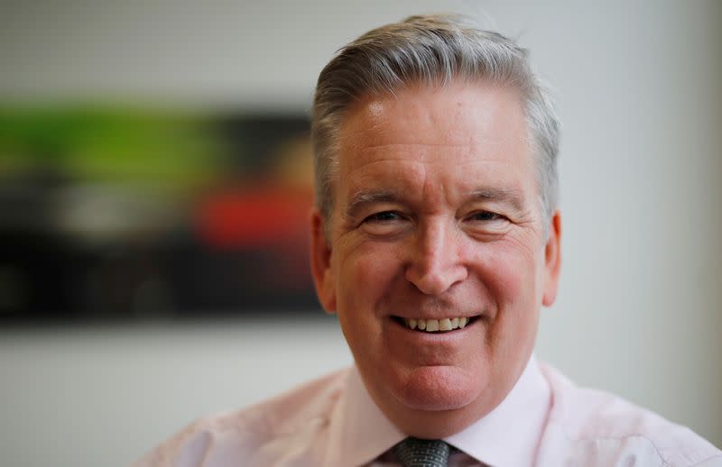 FILE PHOTO: Adrian Hallmark, CEO of Bentley Motors, poses for a photograph at their factory in Crewe