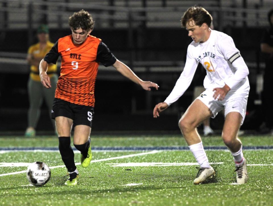 Ryle's Brice Denigan (9) and St. Xavier's Frankie Klein (21) as Ryle and St. Xavier faced off in the KHSAA boys soccer state semifinals Oct. 25, 2023 at Lafayette High School, Lexington, Ky.