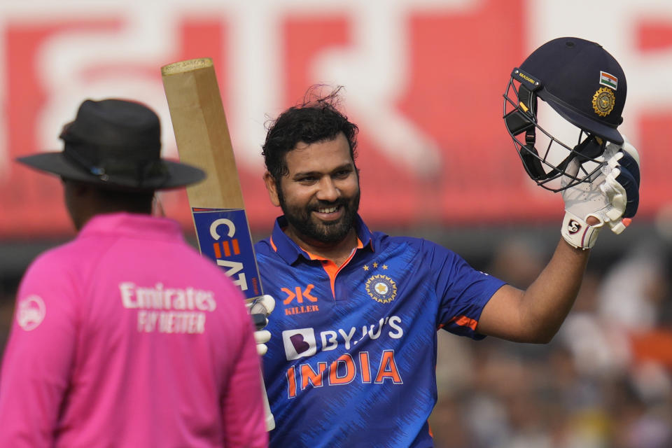 India's captain Rohit Sharma raises his bat to celebrate scoring a century during the third one-day international cricket match between India and New Zealand in Indore, India, Tuesday, Jan. 24, 2023. (AP Photo/Rajanish Kakade)