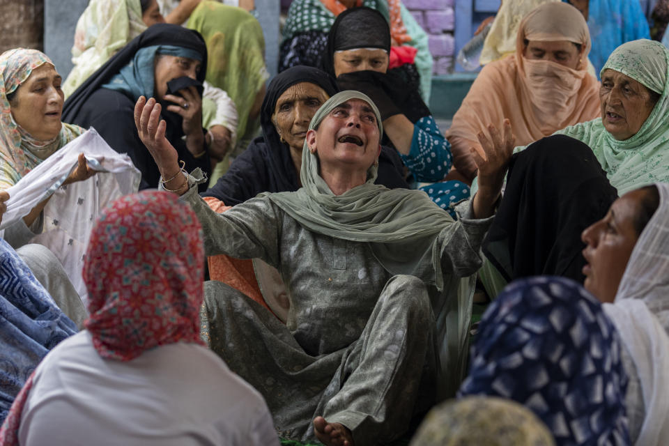 Unidentified relatives of Waseem Sarvar Bhat, an Indian army solider who was killed in a gunfight with suspected rebels, grieve at his residence in Bandipora, north of Srinagar, Indian controlled Kashmir, Saturday, Aug. 5, 2023. Three Indian soldiers were killed in a gunbattle with rebels fighting against New Delhi’s rule in Kashmir, officials said Saturday, as authorities stepped up security on the fourth anniversary since India revoked the disputed region’s special status. (AP Photo/Dar Yasin)