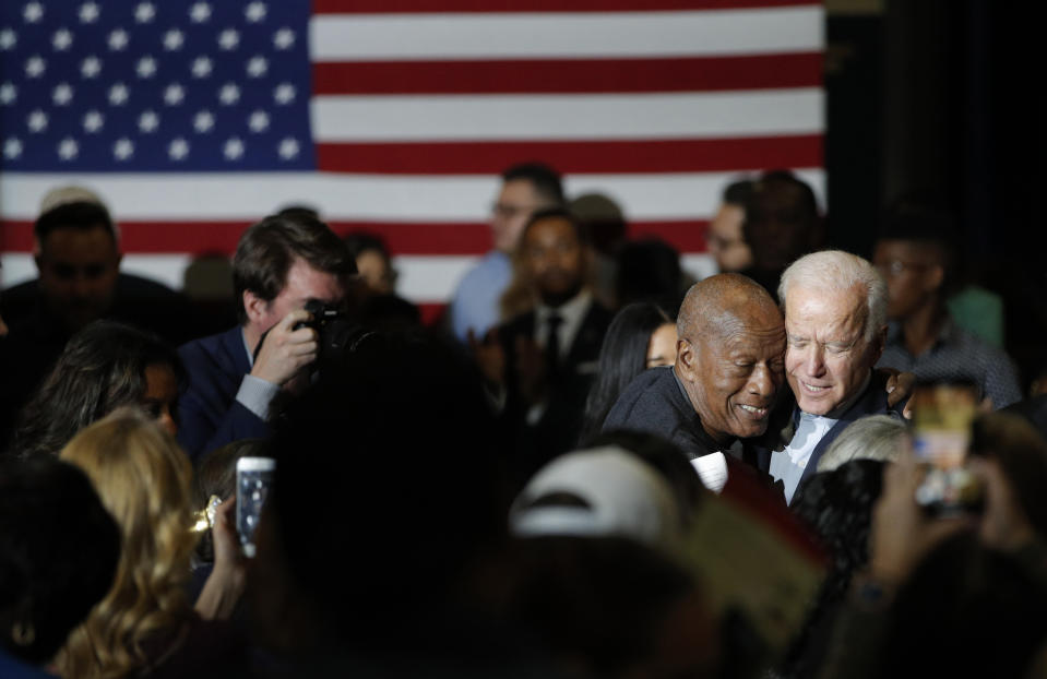 Former Vice President and Democratic presidential candidate Joe Biden, right, embraces a supporter at a campaign event, Saturday, Nov. 16, 2019, in Las Vegas. (AP Photo/John Locher)