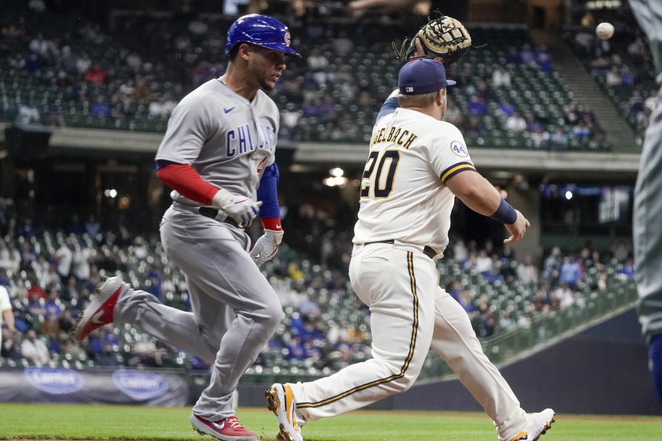 Chicago Cubs' Willson Contreras beats a throw to first with Milwaukee Brewers' Daniel Vogelbach covering during the third inning of a baseball game Monday, April 12, 2021, in Milwaukee. (AP Photo/Morry Gash)