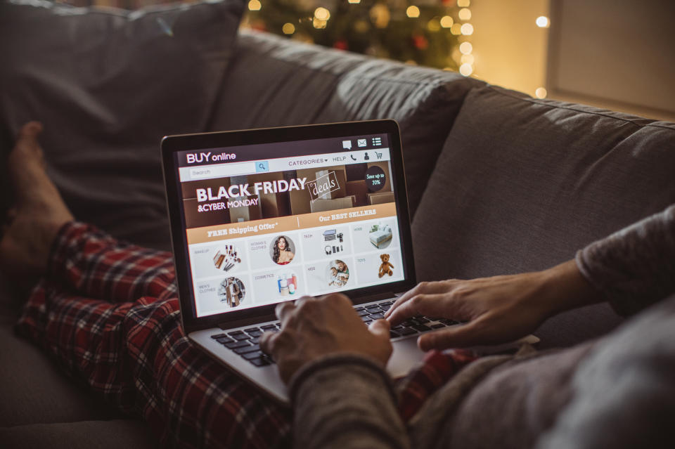 Man shopping online on his laptop, it is Christmas time for shopping