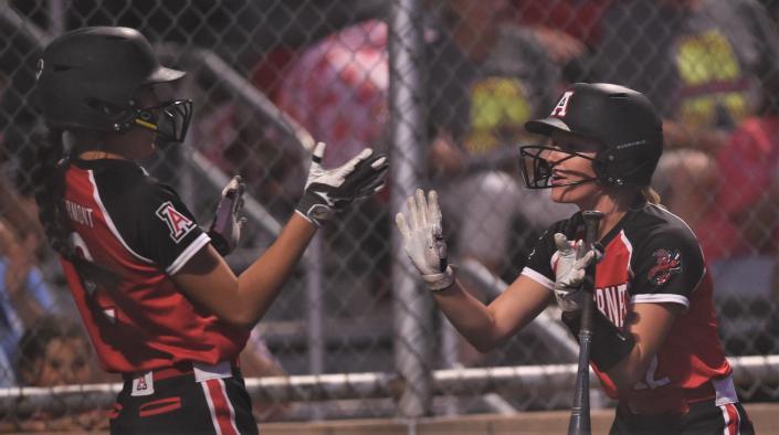 Aspermont&#39;s Jessi Rabel, left, and Payton Potts celebrate after Rabel scored on Kelly Lowack&#39;s single in the second inning.