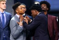 <p>De’Aaron Fox helps adjust the bowtie of Markelle Fultz before the first round of the 2017 NBA Draft at Barclays Center on June 22, 2017 in New York City. </p>