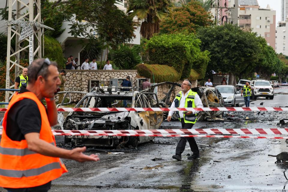 Emergency personnel secure the scene following a rocket attack in Ashdod, Israel, on Monday. (Ahmad Gharabli/AFP via Getty Images)