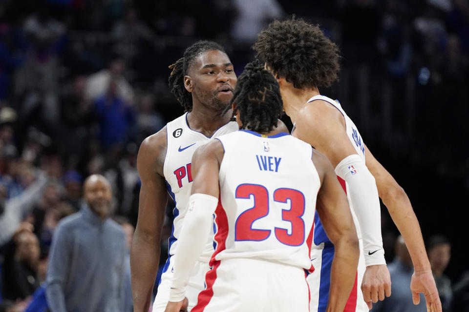 Detroit Pistons center Isaiah Stewart is greeted by guard Cade Cunningham, right, and guard Jaden Ivey (23) after hitting a three-point basket with seconds remain during the second half of an NBA basketball game against the Orlando Magic, Wednesday, Oct. 19, 2022, in Detroit. (AP Photo/Carlos Osorio)