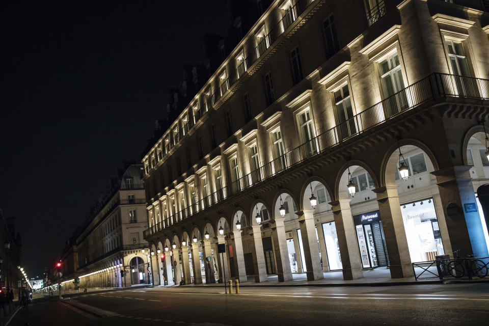 Rivoli street is empty during curfew in Paris, Saturday, Oct. 17, 2020. French restaurants, cinemas and theaters are trying to figure out how to survive a new curfew aimed at stemming the flow of record new coronavirus infections. The monthlong curfew came into effect Friday at midnight, and France is deploying 12,000 extra police to enforce it. (AP Photo/Lewis Joly)