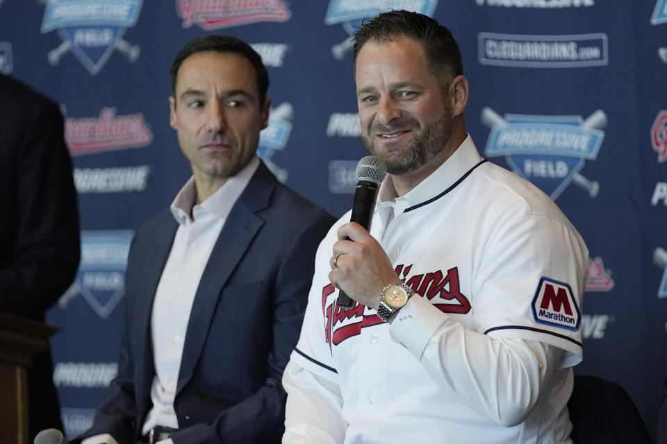Chris Antonetti, left, president of baseball operations, looks on as Stephen Vogt, right, speaks during a news conference introducing him as the manager for the Cleveland Guardians at a news conference Friday, Nov. 10, 2023, in Cleveland. (AP Photo/Sue Ogrocki)