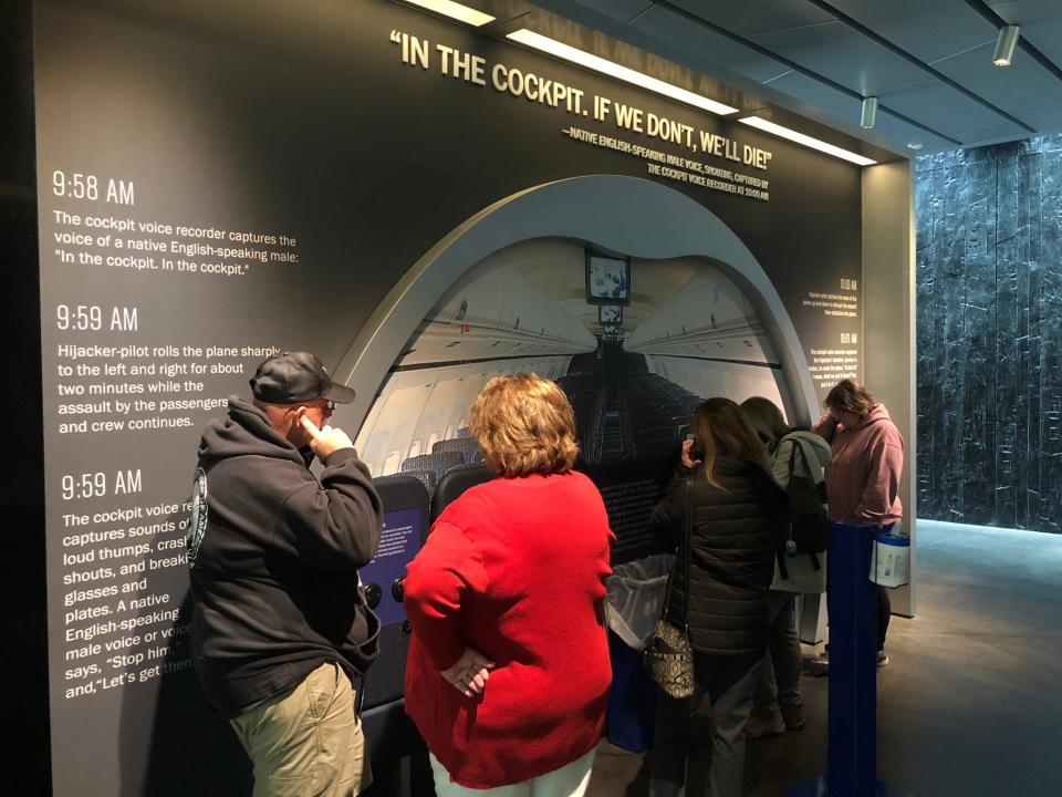Visitors listen on airplane phones to recordings of Flight 93 passengers calling their loved ones from the hijacked plane.
