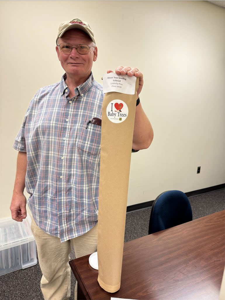 Dr. Alvin Diamond with the moon tree, a loblolly pine