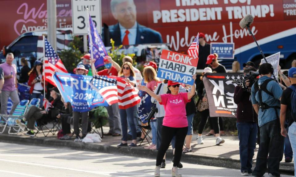 Supporters await Trump’s return along the route to Mar-a-Lago in West Palm Beach, Florida, on 20 January.