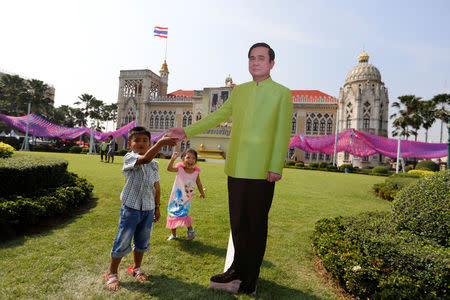 Children play next to a cardboard cutout of Thailand's Prime Minister Prayuth Chan-ocha during the Children's Day celebration at Government House in Bangkok, Thailand, January 13, 2018. REUTERS/Jorge Silva