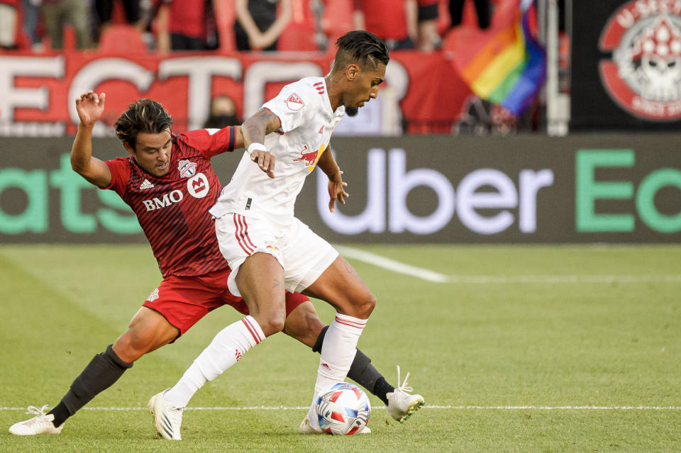 New York Red Bulls forward Fabio, right, is defended by Toronto FC forward Tsubasa Endoh during the first half of an MLS soccer match Wednesday, July 21, 2021, in Toronto. (Chris Katsarov/The Canadian Press via AP)
