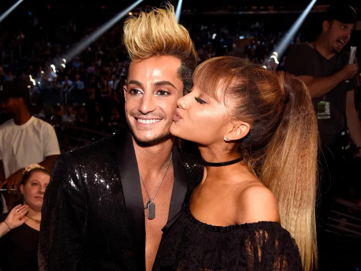 Ariana kissing Frankie on the cheek.