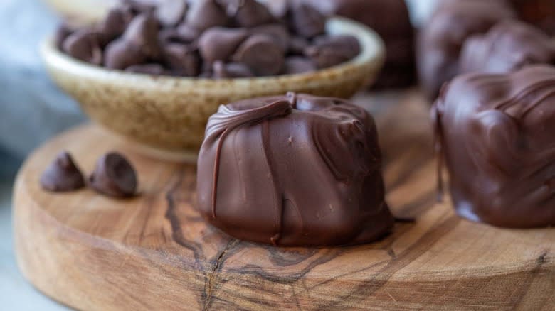 chocolate-coated brie cheese on wooden board