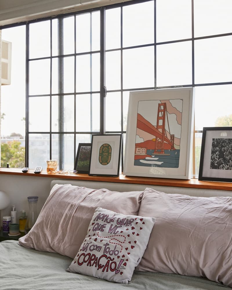 Art prints on window ledge in bedroom.