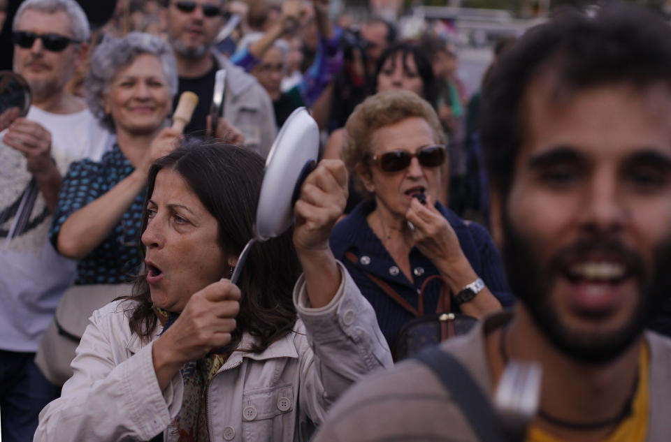 Protestors bang pots against austerity measures announced by the Spanish government in Madrid, Spain, Saturday, Oct. 13, 2012. Several thousand people noisily banging pots and pans are marching down Madrid's main north-to-south boulevard protesting the government's austerity measures. With unemployment nearing 25 percent, Spain has introduced biting austerity measure as well as financial and labor reforms in a desperate bid to lower its deficit and assuage investors' misgivings. (AP Photo/Andres Kudacki)