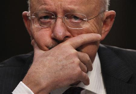 U.S. Director of National Intelligence James Clapper reacts as he testifies at a Senate Intelligence Committee hearing the Foreign Intelligence Surveillance Act legislation on Capitol Hill in Washington, September 26, 2013. REUTERS/Jason Reed (UNITED STATES - Tags: POLITICS)