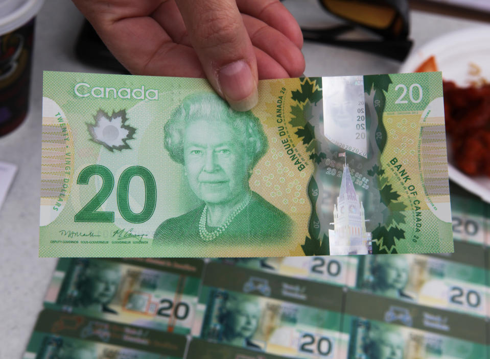 An official shows off the new polymer $20 Dollar bill which is still uncalculated and will begin to be introduced into circulation later this year in Mississauga, Ontario, Canada on September 15, 2012. The bill is being shown to members of the business community to explain the enhanced and newly added security features meant to prevent counterfeiting. (Photo by Creative Touch Imaging Ltd./NurPhoto via Getty Images)