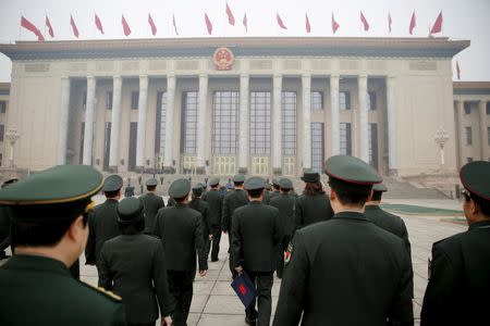 Military delegates arrive at the Great Hall of the People before a meeting ahead of Saturday's opening ceremony of the National People's Congress (NPC), in Beijing, China March 4, 2016. REUTERS/Damir Sagolj