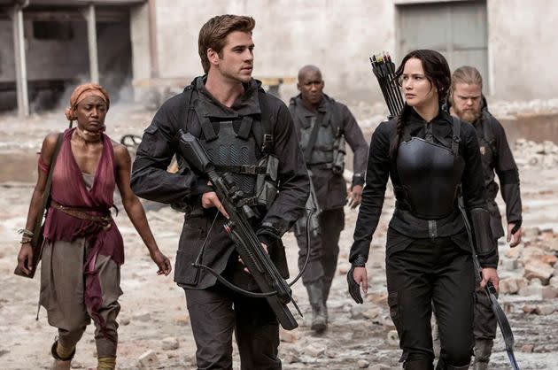 Jennifer Lawrence as Katniss Everdeen and Liam Hemsworth as Gale Hawthorne