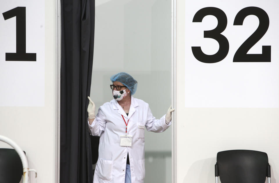 A nurse waits at a vaccination booth, in the center for vaccination against COVID-19, at A1 Arena in Skopje, North Macedonia, on Tuesday, May 4, 2021. The European Union started delivering EU-funded coronavirus vaccines Tuesday to the Balkans, a region that wants to join the 27-nation bloc but where China and Russia have already been supplying the much-needed shots and making political gains. (AP Photo/Boris Grdanoski)