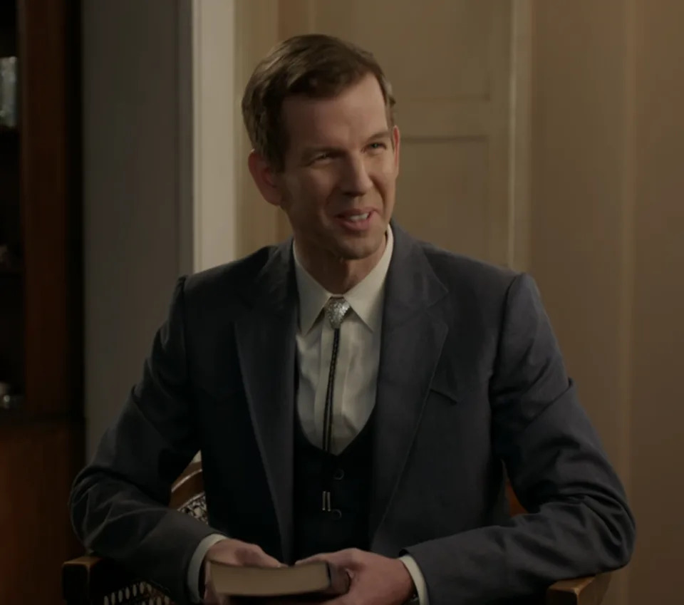 Jeff seated in a suit with his Bible in hand