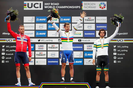 Cycling - UCI Road World Championships - Men Elite Road Race - Bergen, Norway - September 24, 2017 - Gold medalist Peter Sagan (C) of Slovakia, silver medalist Alexander Kristoff (L) of Norway and bronze medalist Michael Matthews of Australia react on the podium. NTB SCANPIX/Cornelius Poppe via REUTERS