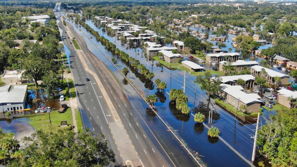 After Tropical Storm Ian was done thrashing Florida in late September 2022 and pushed out into the Atlantic Ocean, Daytona Beach's Midtown neighborhood remained underwater for days. Pictured is Nova Road looking north and the Midtown neighborhood to its east still swimming in floodwater surrounding the two-story Gardens of Daytona apartment buildings and one-story Caroline Village public housing units.