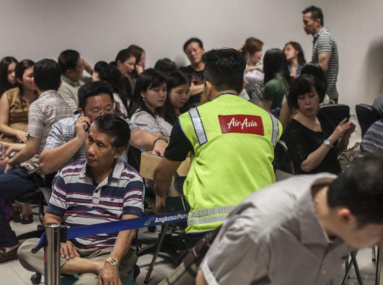 Family members of passengers on missing AirAsia Flight QZ8501 gather at the airport in Surabaya, East Java, as they await news on the fate of their relatives