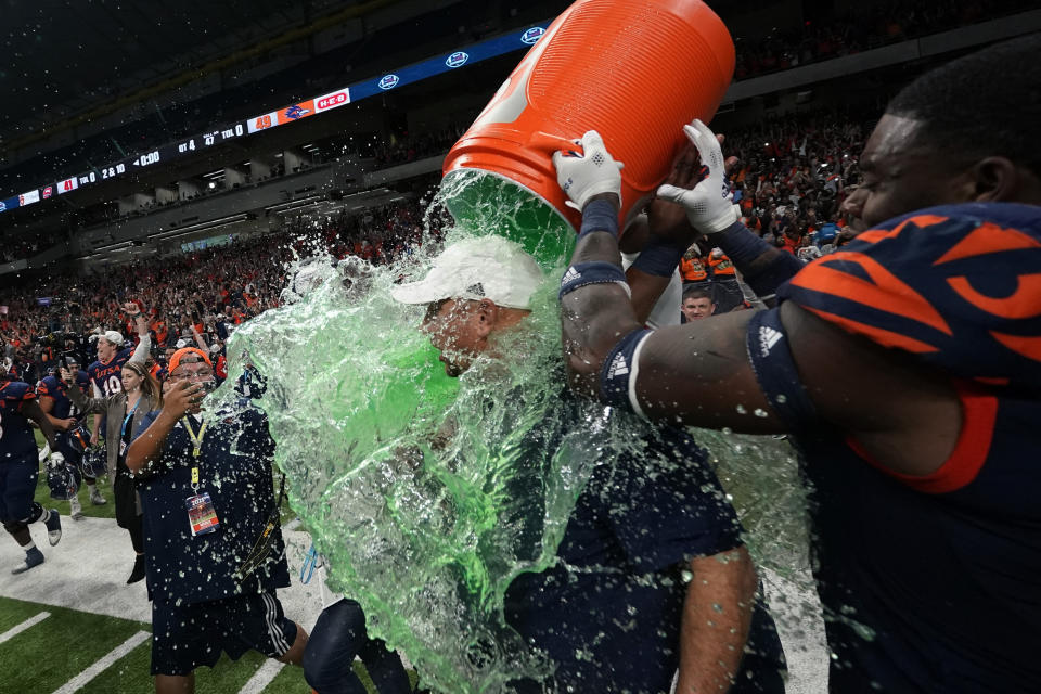 UTSA head coach Jeff Traylor, center, is doused by his players after the team's win over Western Kentucky in an NCAA college football game in the Conference USA Championship, Friday, Dec. 3, 2021, in San Antonio. (AP Photo/Eric Gay)