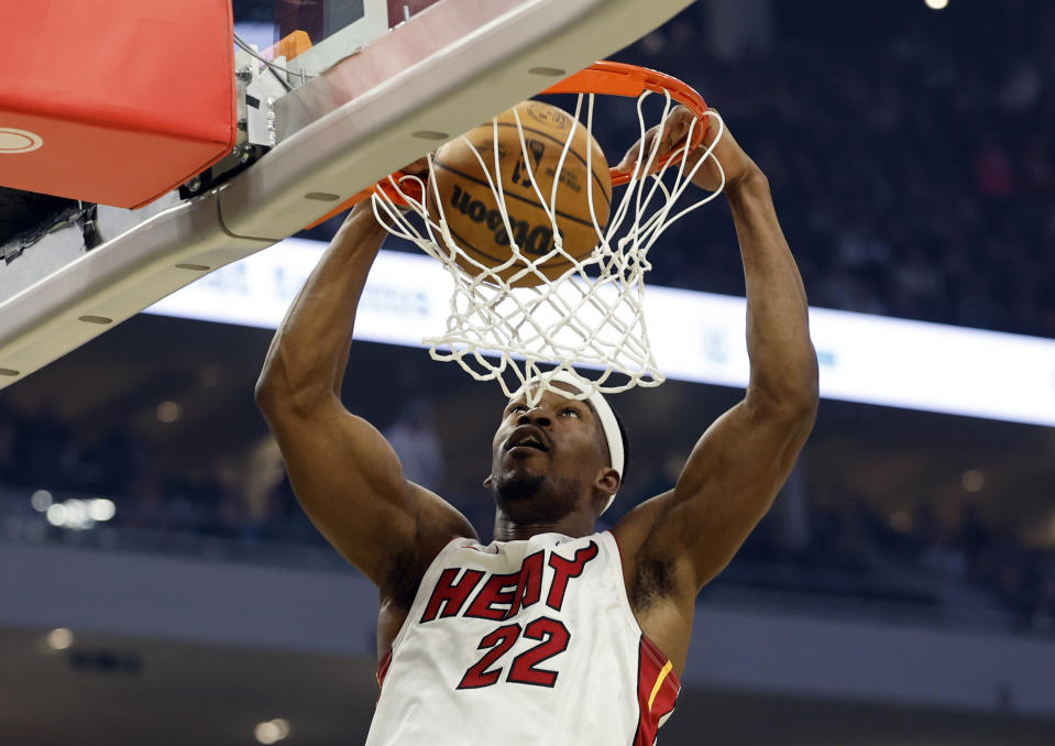 Miami Heat forward Jimmy Butler (22) dunks the ball against the Milwaukee Bucks during the first half of Game 5 in a first-round NBA basketball playoff series Wednesday, April 26, 2023, in Milwaukee. (AP Photo/Jeffrey Phelps)