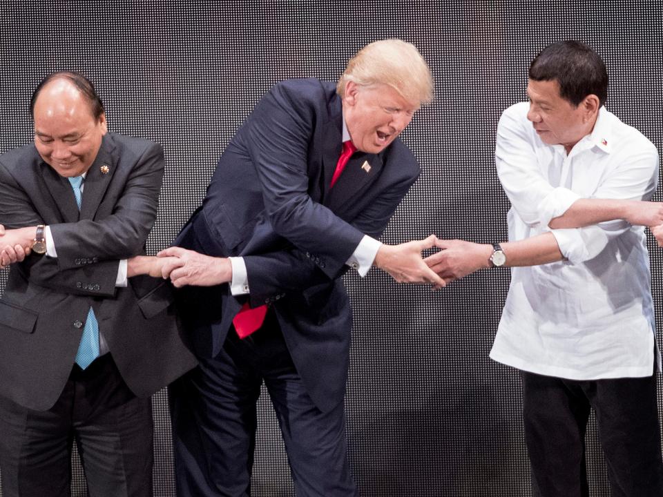 President Trump, Vietnam’s Prime Minister Nguyen Xuan Phuc and Philippine President Rodrigo Duterte join hands for the family photo during the 31st Association of South East Asian Nations, 13 November 2017JIM WATSON/ AFP via Getty Images