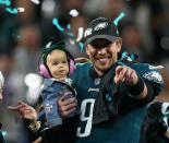 <p>Philadelphia Eagles quarterback Nick Foles (9) celebrates with daughter Lily after defeating the New England Patriots in Super Bowl LII at U.S. Bank Stadium. Mandatory Credit: Mark J. Rebilas-USA TODAY Sports </p>