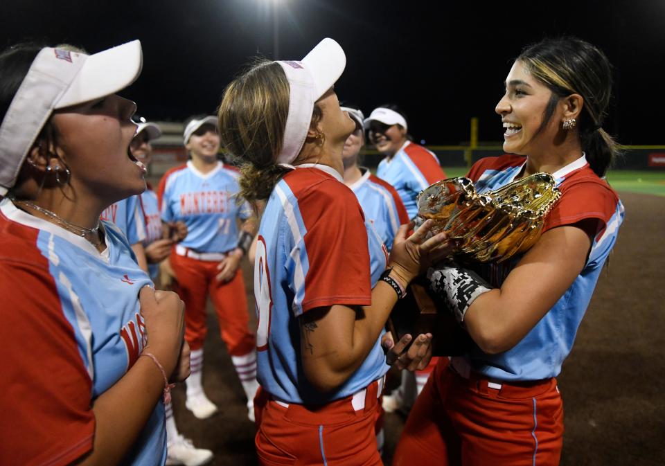 Monterey's Anays Perez, far right, holds the Region I-5A quarterfinal softball trophy after the team's win against Lubbock-Cooper, Friday, May 10, 2024, at First United Park in Woodrow.
