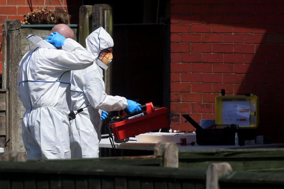 Forensics swarm a property in Elsmore Road (Danny Lawson/PA)