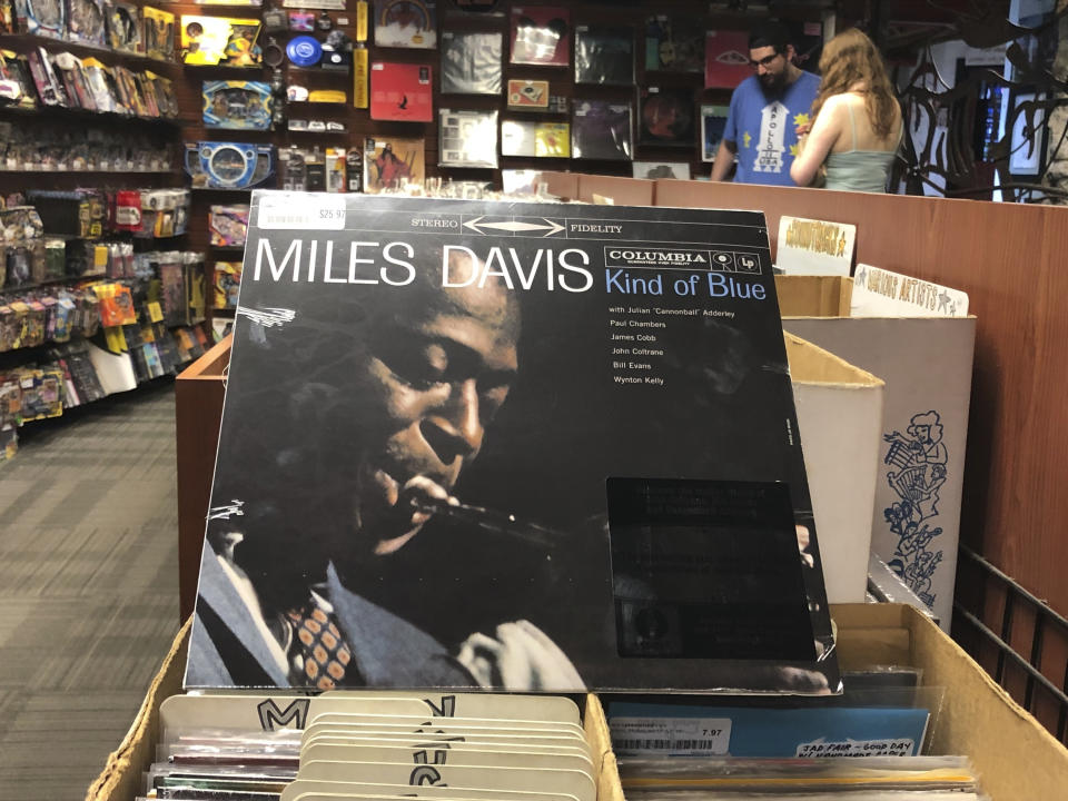 FILE - In this Aug. 17, 2019, file photo, the "Kind of Blue" album cover is on display at Bull Moose record store in Portland, Maine, on the 60th anniversary of the album's release. Drummer Jimmy Cobb, the last surviving musician who performed on Miles Davis' jazz masterpiece "Kind of Blue," died Sunday, May 25, 2020, at his Manhattan home from lung cancer. He was 91. (AP Photo/David Sharp, File)