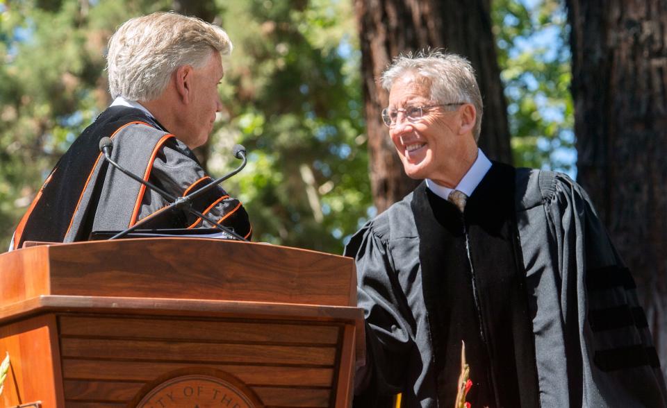 University of the Pacific president Christopher Callahan, left, congratulates Seattle Seahawks head coach Pete Carroll after conferring an honorary MBA degree upon him during the 2022 commencement ceremonies.