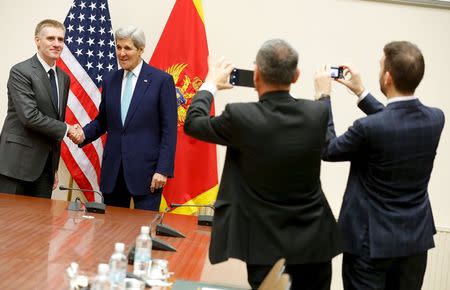 U.S. Secretary of State John Kerry (2nd L) meets Montenegro's Foreign Minister Igor Luksic (L) at the NATO ministerial meetings at NATO Headquarters in Brussels December 2, 2015. REUTERS/Jonathan Ernst