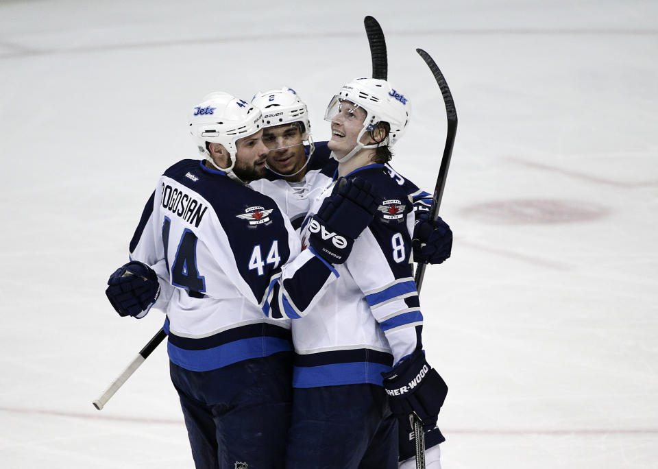 Winnipeg Jets' Evander Kane, center, celebrates his goal with Zach Bogosian, left, and Jacob Trouba during the second period of an NHL hockey game against the Anaheim Ducks, Tuesday, Jan. 21, 2014, in Anaheim, Calif. (AP Photo/Jae C. Hong)