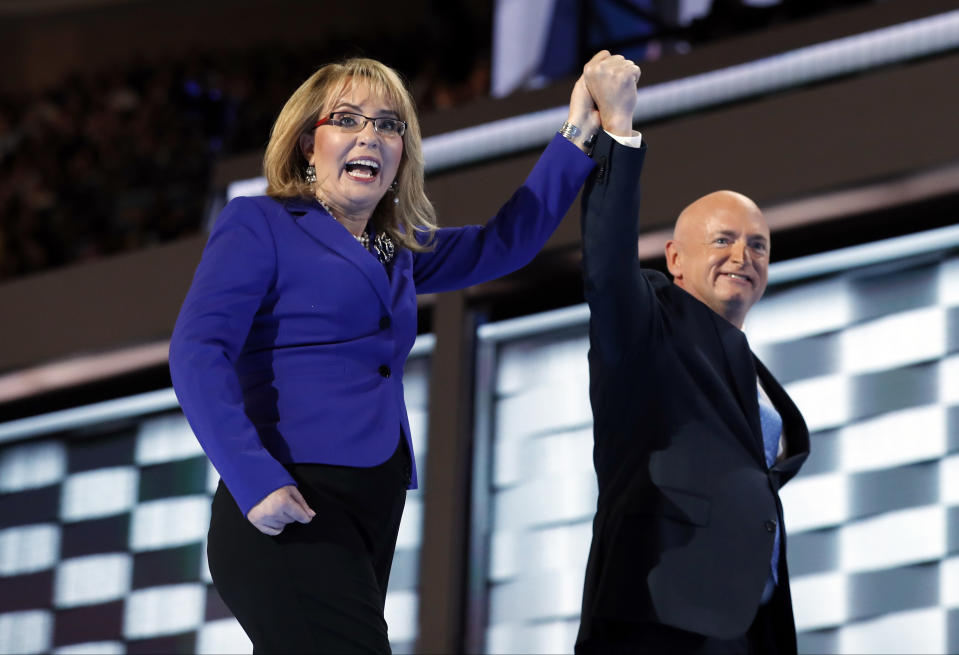 FILE - In this July 27, 2016, file photo, former Rep. Gabby Giffords, D-Ariz, and her husband Astronaut Mark Kelly (ret.), walk off the stage after speaking during the Democratic National Convention in Philadelphia. As a mob laid siege to the U.S. Capitol this week, former Rep. Giffords waited nervously for news about her husband, Kelly, who was barely a month into his job as a newly elected senator from Arizona. A decade earlier it was Kelly enduring the excruciating wait for news about Giffords, who was shot in the head in an attempted assassination that, like the siege, Jan. 6, 2021, shocked the nation and prompted a reckoning about the state of politics and discourse in the U.S. (AP Photo/Carolyn Kaster, File)