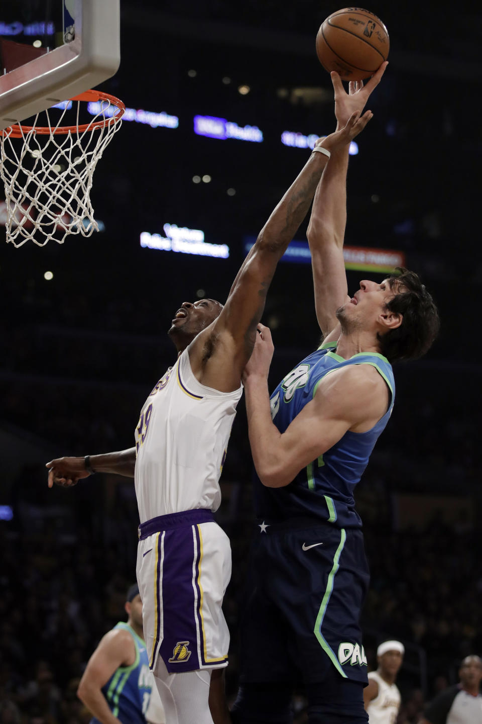Los Angeles Lakers' Dwight Howard, left, works for a rebound against Dallas Mavericks' Boban Marjanovic during the first half of an NBA basketball game Sunday, Dec. 1, 2019, in Los Angeles. (AP Photo/Marcio Jose Sanchez)