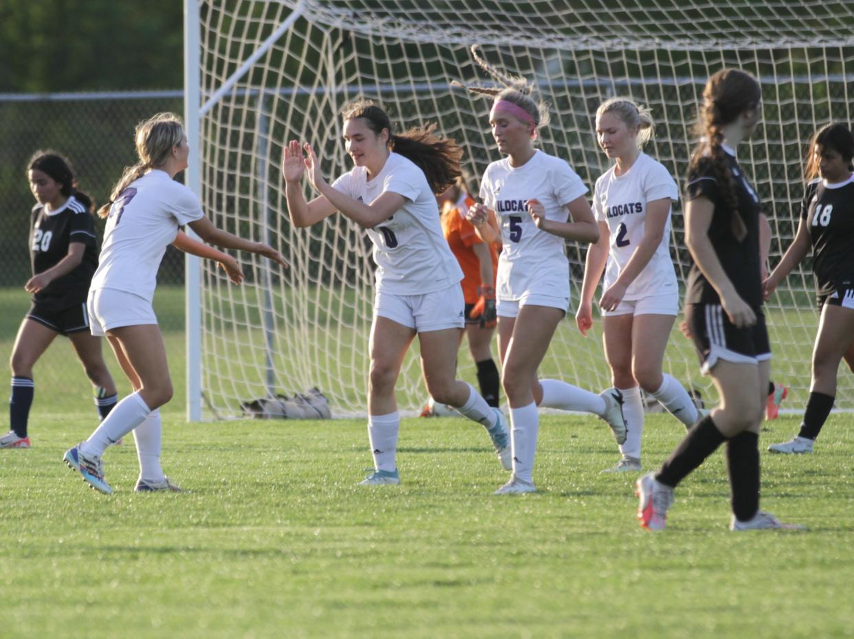 Three Rivers' Natalie McGahan shares a high-five with teammate Savannah Morrill after scoring a goal on Monday.