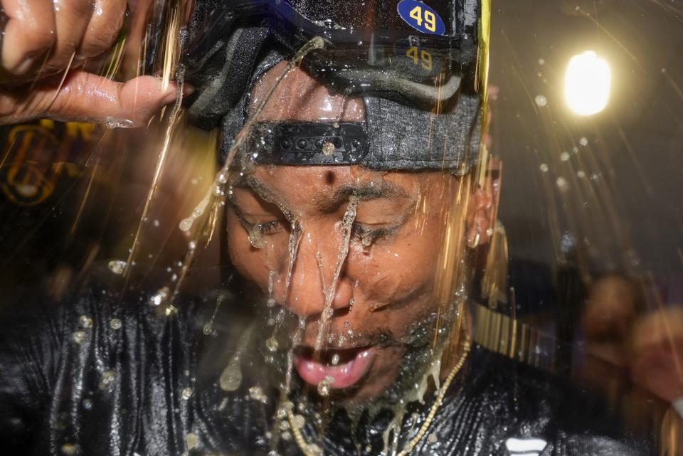 Milwaukee Brewers' Enoli Paredes is douced after a baseball game against the Philadelphia Phillies Wednesday, Sept. 18, 2024, in Milwaukee. The Brewers won 2-1 and clinched the National League Central division. (AP Photo/Morry Gash)