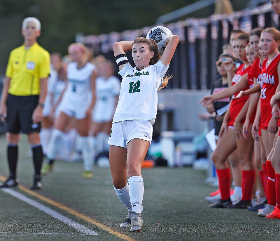 Marshfield captain Ryann Doyle makes a throw-in from in front of the Hingham bench on Tuesday, Sept. 12, 2023.