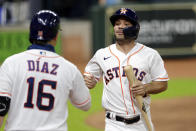 Houston Astros' Aledmys Diaz, left, congratulates Jose Altuve, right, after he scores the go-ahead run on the single by Kyle Tucker during the sixth inning of a baseball game against the Arizona Diamondbacks Saturday, Sept. 19, 2020, in Houston. (AP Photo/Michael Wyke)