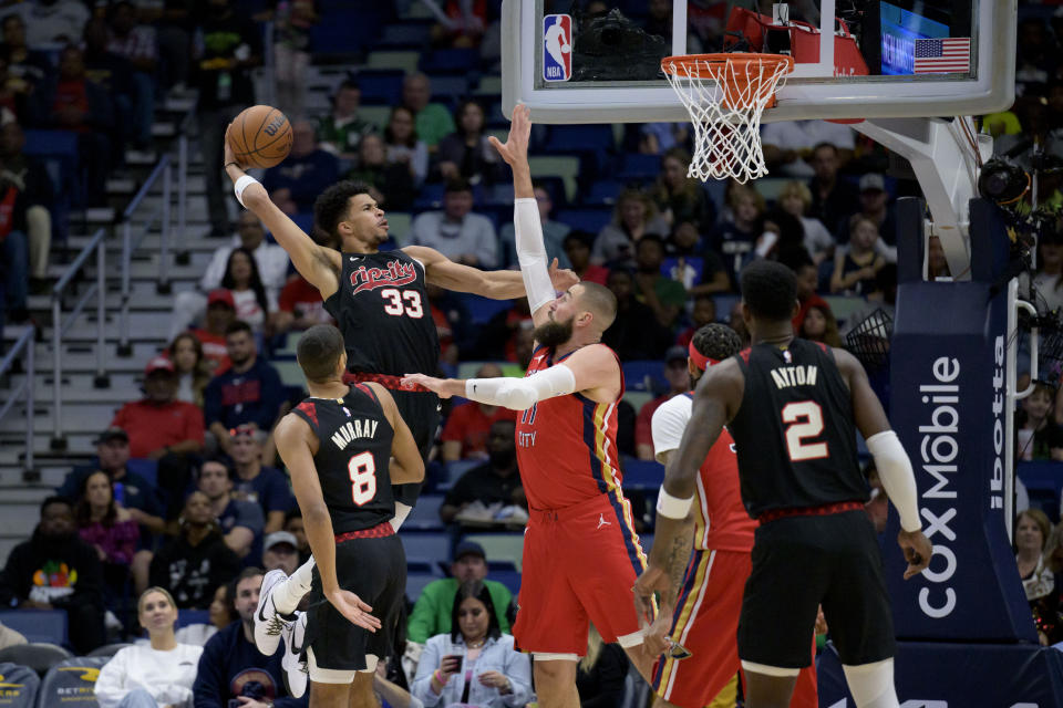 Portland Trail Blazers forward Toumani Camara (33) prepares to dunk against New Orleans Pelicans center Jonas Valanciunas (17) during the first half of an NBA basketball game in New Orleans, Saturday, March 16, 2024. (AP Photo/Matthew Hinton)